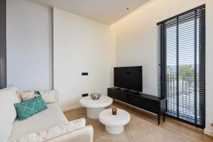 un salon avec un canapé et une télévision à écran plat dans l'établissement Boka Place Porto Montenegro-sea view, à Tivat