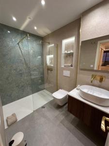 a bathroom with a shower and a sink and a toilet at M&M La Cala Suite in La Cala de Mijas +31 photos