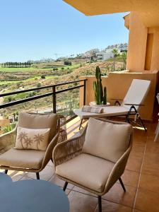 a balcony with chairs and a table and a view at M&M La Cala Suite in La Cala de Mijas