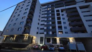 a large building with cars parked in front of it at Stroe House in Iaşi