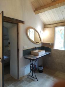a bathroom with a table with a box on it at Le Lauzas in Pénens