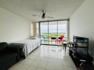 a bedroom with a bed and a table and a balcony at Seaside Serenity in San Juan +38 photos