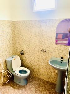 a bathroom with a toilet and a sink at Disna Place in Unawatuna +44 photos