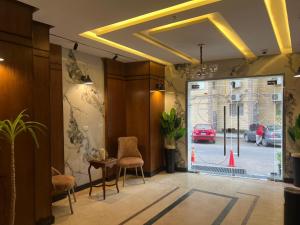 a lobby with a glass door with a red car outside at Nuba Nile Hotel in Aswan