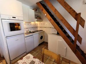 a small kitchen with a sink and a staircase at Résidence Belle - 2 Pièces pour 6 Personnes MAE-2303 in Lanslevillard