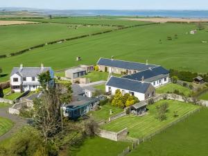 an aerial view of a large house with a green field at The Martin's - Uk48870 in Belford