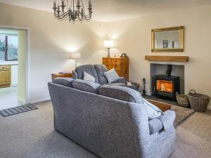 a living room with a couch and a fireplace at The Martin's - Uk48870 in Belford
