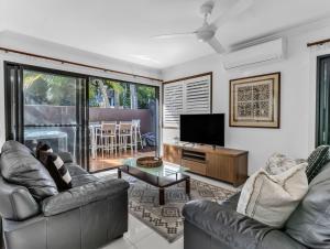 a living room with two couches and a television at Villas at Hastings Point by Kingscliff Accommodation in Hastings Point