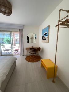 a bedroom with a bed and a table and a desk at Le Loft Bleu Deauville - les Petites Planches in Deauville