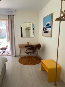 a living room with a table and a mirror at Le Loft Bleu Deauville - les Petites Planches in Deauville