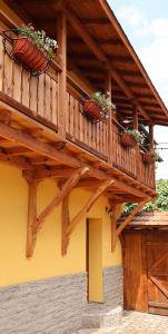 a balcony on a house with potted plants on it at Guest house Dinaya-2 in Dobrinishte
