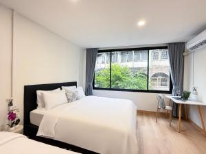 Postel nebo postele na pokoji v ubytování Serenova Hotel Siam Paragon, Bangkok