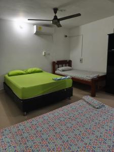a bedroom with two beds and a ceiling at Las Margaritas Frente al Mar 1 in Coveñas +5 photos