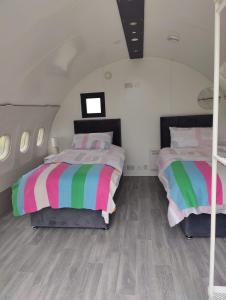 a bedroom with two beds with colorful sheets at Canal Stay in Cloondara