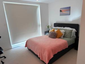 a bedroom with a bed with a large window at Exquisite Spacious 1 Bedroom Apartment-Colindale in Colindale
