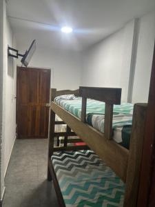 a room with two bunk beds and a door at Cartagena Hostel in Cartagena de Indias