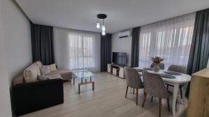 a living room with a couch and a table at Riverside Panorama in Kŭrdzhali