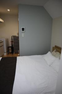 En eller flere senge i et værelse på Tateishi House101