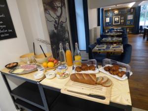 a table with bread and other food on it at La Belle-Croix in Romont