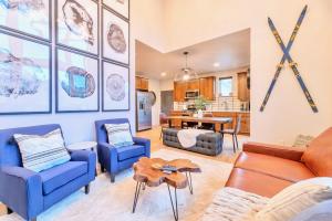 a living room with blue chairs and a table at Luxury 2BR Mountain Townhouse w Picturesque Views in Silverthorne +24 photos