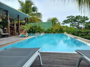 a large swimming pool next to a house at Villa Toc Toc à Bouillante, Guadeloupe in Bouillante