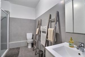 a bathroom with a sink and a toilet and a shower at Rocca Bella Escape by the Sea and Vineyards in Patrimonio