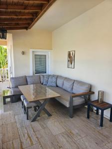 a living room with a couch and a coffee table at Villa Belle ,Fethiye in Fethiye