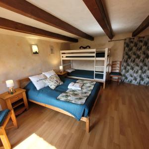 a bedroom with a bed and a bunk bed at la Marcairie in La Bresse