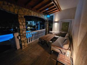 a living room with a couch and a table at Villa Belle ,Fethiye in Fethiye