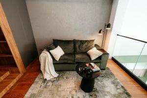 a living room with a couch and a table at Matcha Studio in Bucharest +39 photos