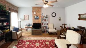 a living room with a couch and a ceiling fan at The Bookend in Rolla