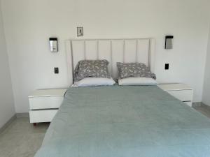 a bedroom with a large bed with two pillows at Mar de Calafia 1 in Divisadero