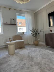 a living room with a chair and a window at Aesthetic Cozy Home Lüdenscheid in Lüdenscheid