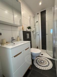 a white bathroom with a toilet and a shower at Aesthetic Cozy Home Lüdenscheid in Lüdenscheid +9 photos