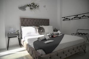 a bedroom with a large bed with a table on it at Villa Irene in Heraklio