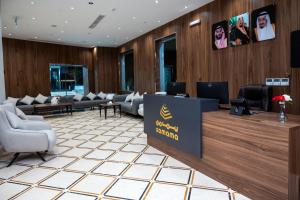 a lobby with a waiting room with couches and a sign at Samama Almaqam Ajyad Hotel Makkah in Mecca