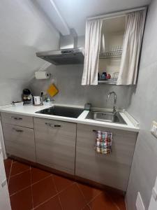 a small kitchen with a sink and a mirror at AL 106 Apartment [Free Wi-fi 5 min dalla Stazione] in Prato +14 photos