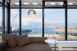 a living room with a couch and a large window at Spacious 2BD in Vancouver Patio with Ocean View in Vancouver