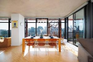 a dining room with a table and a view of the city at Spacious 2BD in Vancouver Patio with Ocean View in Vancouver