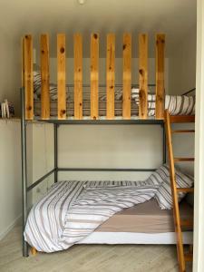 two bunk beds in a small room with at Cottage 50m de la plage in Châtelaillon-Plage