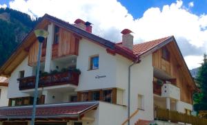 a large house with wooden balconies on the side of it at Appartamenti la Fontana in San Martino in Badia