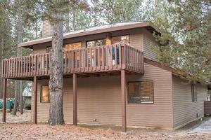 a house with a deck on top of a tree at Sunriver Vacation House in Sunriver