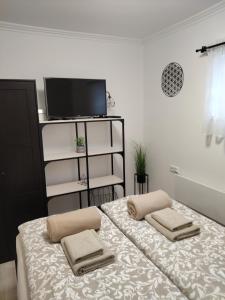 a bedroom with a bed with two pillows on it at Kincsem Vendégház in Tiszakécske +20 photos