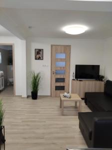a living room with a couch and a table at Kincsem Vendégház in Tiszakécske