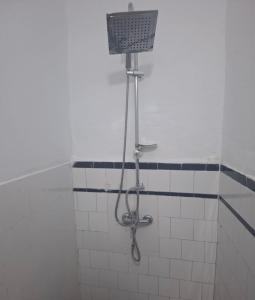 a shower in a bathroom with a basket on the wall at Jennas place in Tangier
