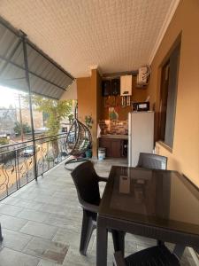 a kitchen with a dining table and a balcony at nino hotel in Kobuleti +32 photos