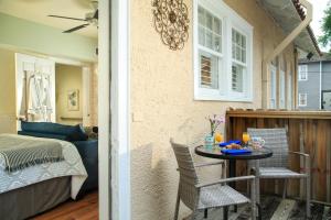a patio with a table and chairs and a bedroom at Casa de Suenos B & B in St. Augustine