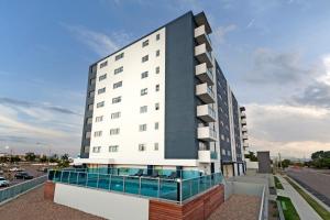a large white building with a lot of windows at Harbourfront Views at Allure 2 Bedroom Apartment in Townsville