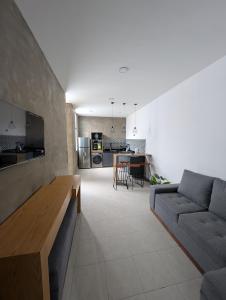 a living room with a couch and a table at Departamentos San Marcos in Aguascalientes