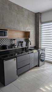 a kitchen with a stove and a dishwasher at Departamentos San Marcos in Aguascalientes +5 photos